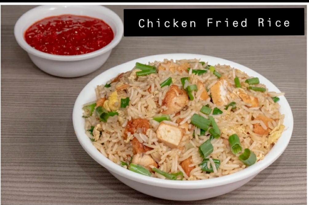 Bowl of chicken fried rice with spring onion